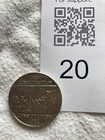 Photo of the coin showing the Confederation assembly design and year 1867-1982 on one side.