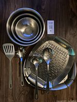 9-piece set including 3 mixing bowls, 2 BBQ platters, and 4 kitchen utensils on wooden surface.