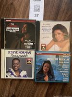 Four opera CDs stacked with visible cover artwork of Jessye Norman and Kathleen Battle.