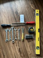 Overview of all tools including DeWalt screwdriver bit set, wrenches, measuring tape, level and screwdrivers