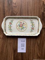 Top-down view of the rectangular serving dish showing the full floral pattern and gold detailing with a white base and side handles.