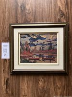 Full view of the framed reproduction artwork showing the frame and hanging hardware attached to the back