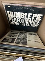 Photo showing top vinyl record Humble Pie Performance Rockin' The Fillmore with visible wear on sleeve edges and surface.