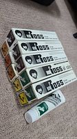 Stack of five Bob Ross oil paint boxes laid flat showing Bob Ross branding on sides and top.