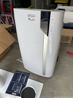 Front view of AC unit showing DeLonghi Pinguino logo, control buttons and housing finish.