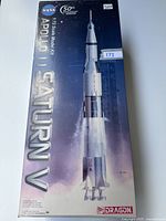 Front view of the unopened Dragon Apollo 11 Saturn V 1:72 scale model kit box showing detailed image of the rocket and branding.