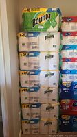 Stack of seven unopened Bounty paper towel packages, six 8=24 packs below and one 12=18 pack on top