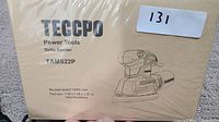 Top view of the beige box packaging showing Teccpo brand, model TAMS22P, product illustration and specifications.