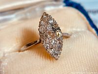 Close-up of ring top showing marquise cluster of mine and old European cut diamonds