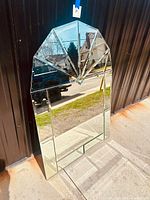 Full view of large vintage bevelled glass mirror with Art Deco fan pattern and diamond centerpiece showing overall shape and design.