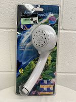 Full packaged view of the Aqua Massage showerhead showing branding, packaging, and overall product.