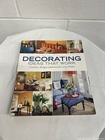 Front view of the book showing the cover with interior design photos.