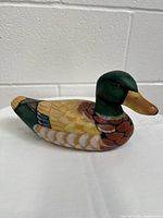 Side view of hand painted carved wooden mallard duck showing detailed paint and carving