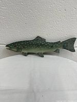 Side view of the handmade fish-shaped wooden key hanger showing detailed paint and texture.