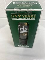 Photo of the glass box front showing a cutout window displaying the glass and text '175 Years Probably the Best Beer in the World'.