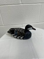 Front view of the wooden duck sculpture showing hand-painted detailed feathers and realistic coloration.
