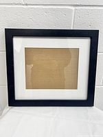 Front view of the black wood picture frame with glass and white matting showing its full 14x16 inch size.
