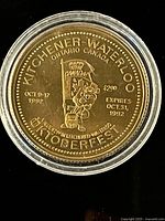 Obverse of coin in capsule showing mascot, date and $2 value
