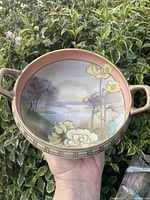 Top view of the hand painted Nippon bowl showing handles, landscape scene and floral motif