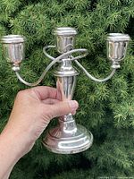 front view of three-arm silver-plate candelabra