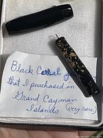Two black coral pieces in box with note
