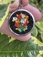 front view of pendant showing floral micro mosaic