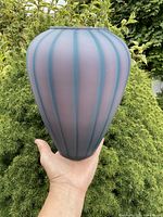 Full view of satin glass vase showing tapered ovoid shape and color