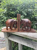 Front view of both wooden elephant bookends side by side