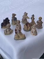 Eight of the ten Wade Red Rose Tea figurines grouped on table