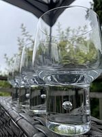 Side view of three bubble stem lowball glasses on patio table