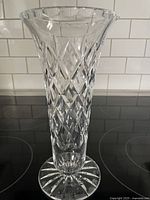 Full view of signed Webb Corbett crystal trumpet vase showing diamond cut pattern and starburst base