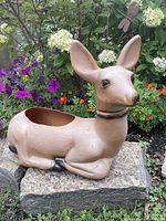 Front left view of blow-mold deer planter in garden setting