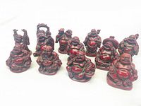 Front view of all 12 miniature laughing Buddha figurines showing various poses and designs.