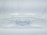 Side angled view showing clear and slightly curved edges with thick base of the Nambe crystal rectangular dish.