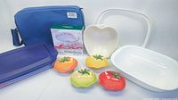 Photo of the portable casserole set with blue carrier, Corelle white rectangular dish, white apple-shaped dish and small colorful ceramic covered dishes shaped like vegetables, plus plastic lid and boxed Pfaltzgraff items.