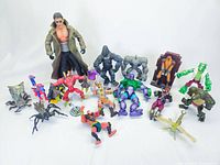 Full lot of 16 assorted vintage action figures shown on white background from a frontal angle