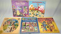Five children's 12-inch vinyl records including Snow White, Smurfing Sing Song, Benji, 8 Bedtime Stories, and Childrens Songs and Stories with colorful illustrated covers.