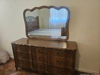 Front view of the French Provincial wood triple dresser with attached mirror showing dresser top and drawer design.
