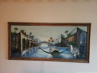 Full view of the large painting featuring the Venice canal scene with buildings and bridge, unlit.