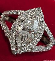 Top-angled view showing marquise center stone, halo setting, split shank