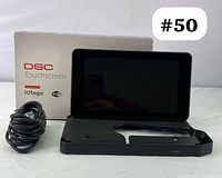 Front view of DSC touchscreen panel with mounting bracket, cable, and box visible