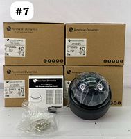 Set of 4 American Dynamics Discover 300 Series high resolution indoor dome cameras in their original packaging along with one camera unpacked, showing the dome lens and accompanying instructions and mounting hardware.