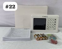 Keypad device front view with screen, buttons, 4 AA batteries, mounting hardware, user manual, and box.