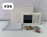 Complete lot including DSC WK250 wireless security keypad, user manual, 6 AA batteries, mounting screws, anchors, and original box.