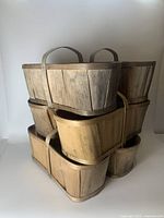 Stacked view of 6 vintage wooden apple/fruit baskets with handles, showing natural wood grain and varying patina.