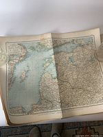 Open antique map showing Russia and Baltic Sea region with detailed borders and towns.