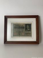 Full view of framed 10,000 German Mark note showing cherry wood frame and white mat with blue groove detail