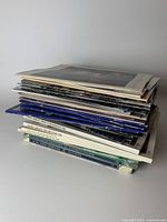 Stack of Laura Ashley design books and magazines showing spines with vintage titles