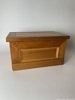 Side view of the pine jewelry box showing the panel detailing and warm wood finish.