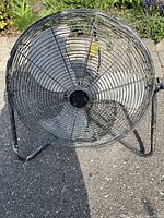 Front view of the Mastercraft construction fan showing metal grille and blades.